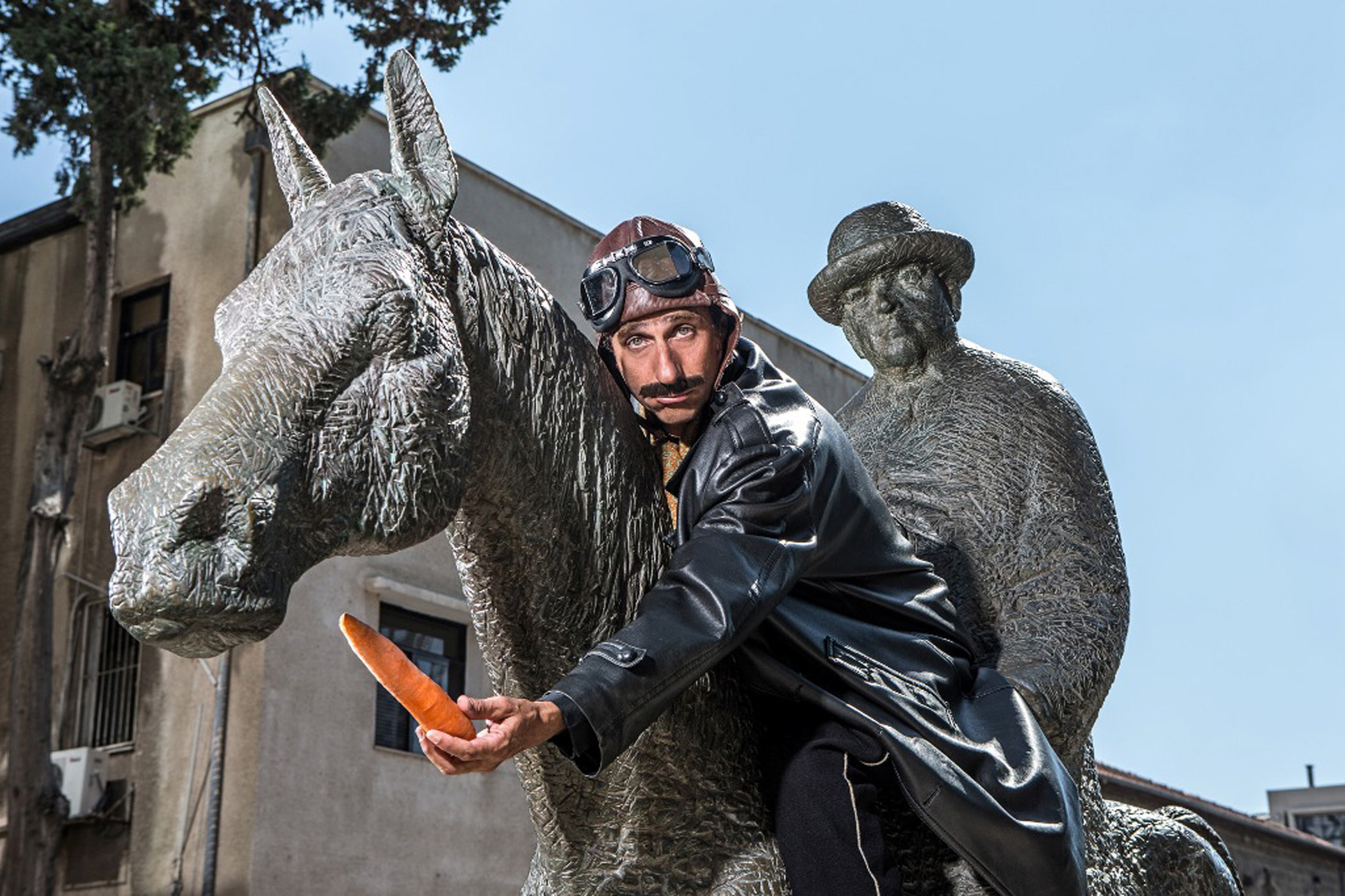 Actor/guide on a statue of Tel Aviv's first mayor, Meir Dizengoff riding his horse    Photo courtesy of Tarbush Tours